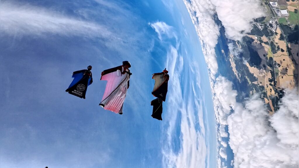 Flock of wingsuit flyers in Aros Sweden